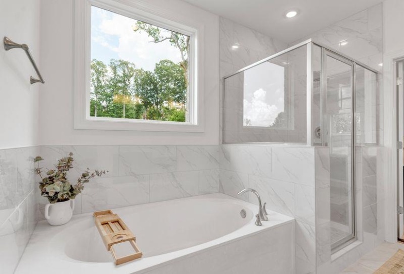 Full bath with a bath and a marble finish shower