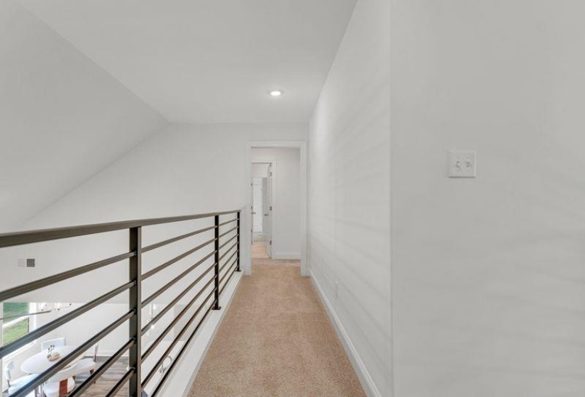 Hall with light colored carpet, recessed lighting, and lofted ceiling