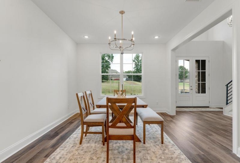 Dining room , dark wood-type flooring, a chandelier, and recessed lighting