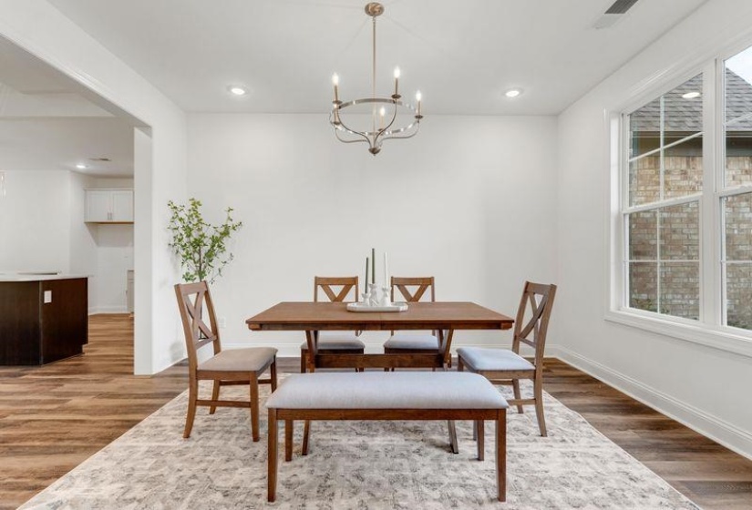 Dining space featuring light wood-type flooring, a chandelier, and recessed lighting