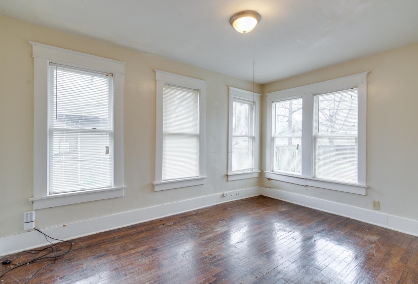 Unfurnished dining area with plenty of natural light and dark wood-type flooring