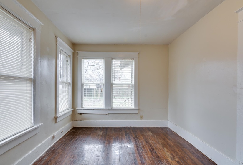 Spare room with plenty of natural light and dark wood-style flooring