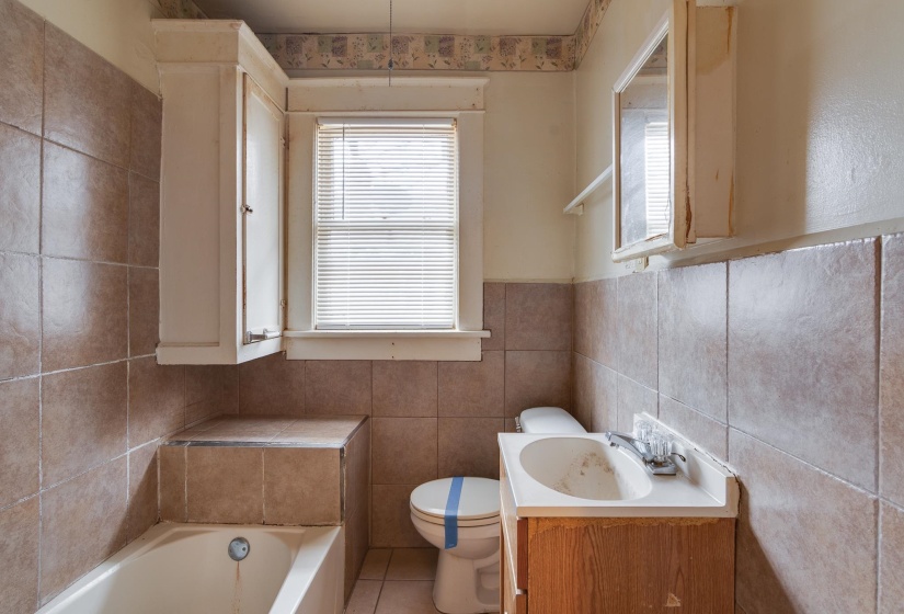 Full bathroom featuring a garden tub, tile walls, vanity, and tile patterned floors