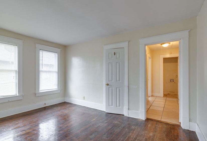 Unfurnished room with dark wood-style floors and baseboards