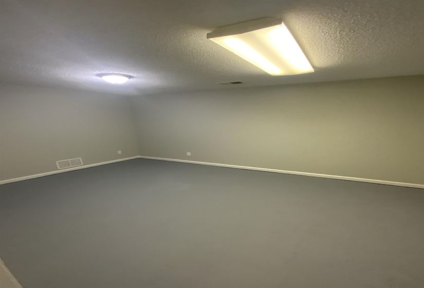 Unfurnished room featuring a textured ceiling