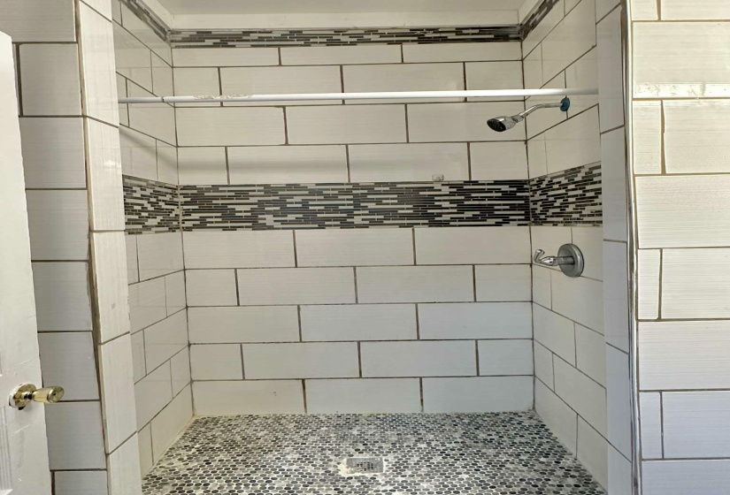 Full bath with a shower stall