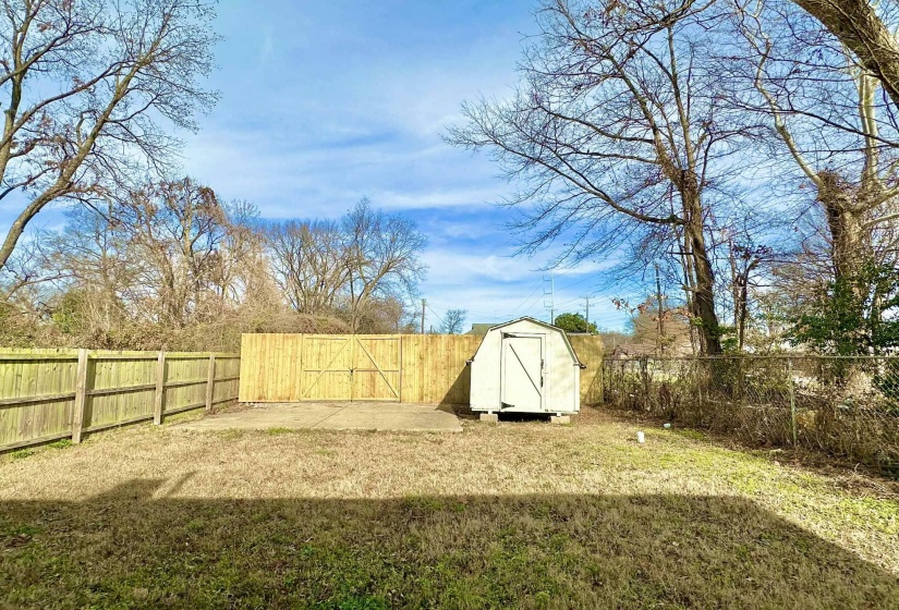 Fenced backyard with a storage shed