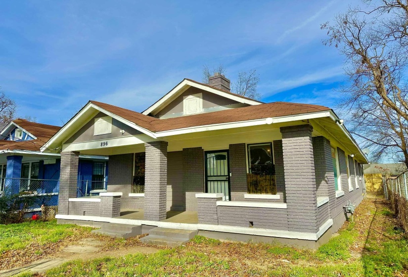 Bungalow-style house with a porch, brick siding, and a chimney