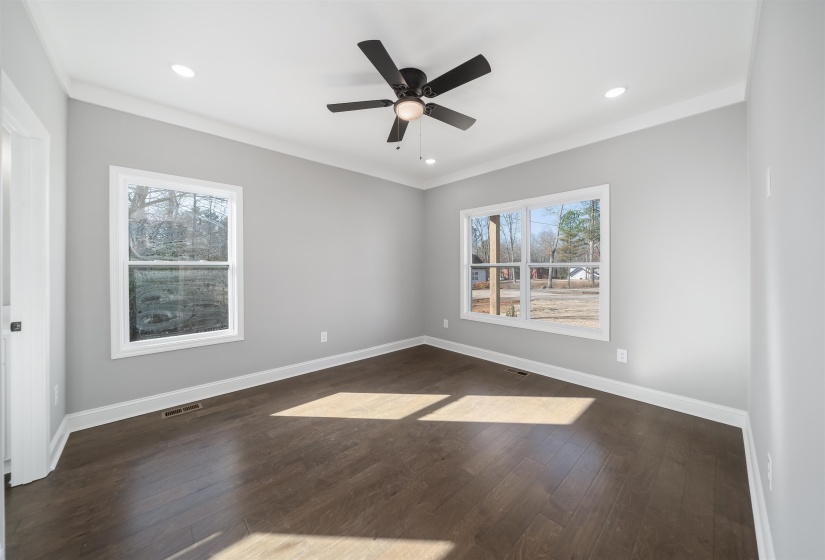 Unfurnished room featuring dark wood-type flooring, ceiling fan, recessed lighting, and ornamental molding