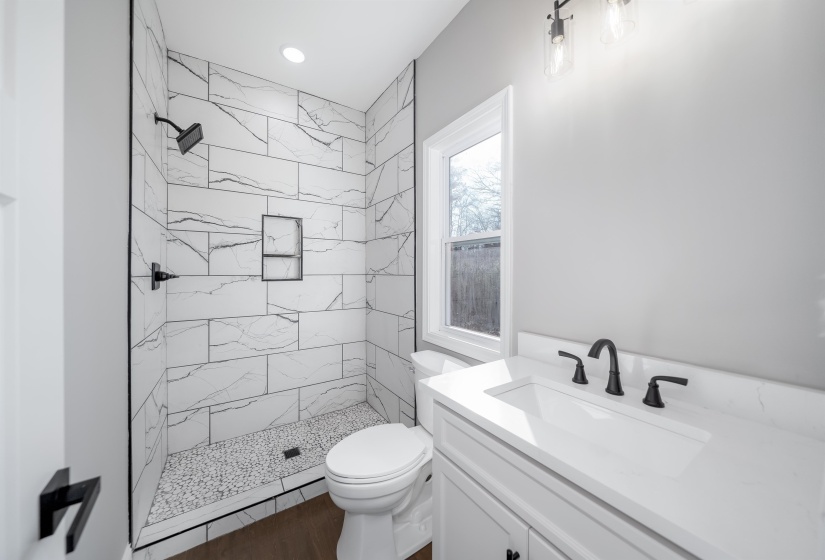 Full bath featuring vanity, a marble finish shower, and recessed lighting