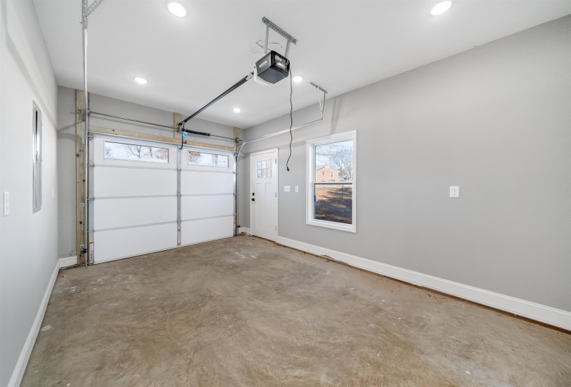 Garage featuring a garage door opener and recessed lighting