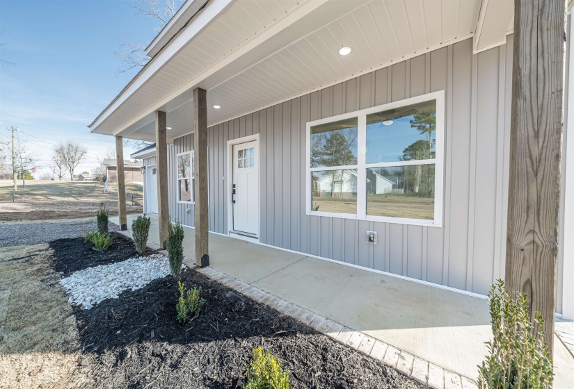 View of exterior entry with a porch and board and batten siding