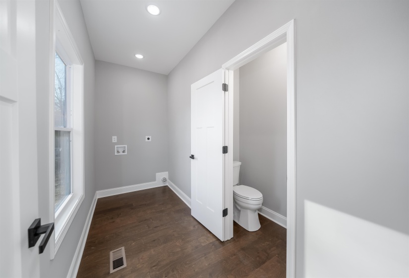 Bathroom with dark wood-style flooring and recessed lighting
