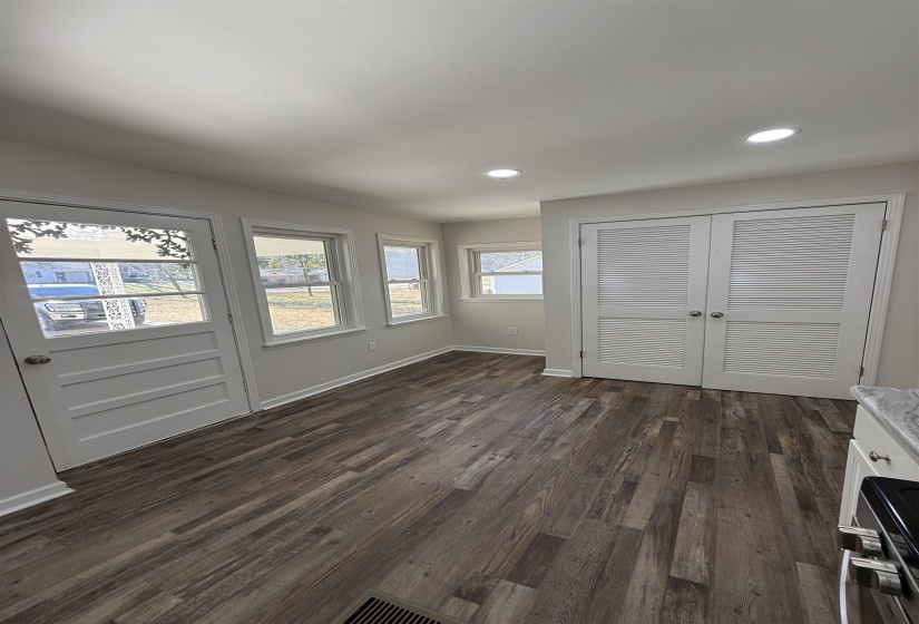 Unfurnished dining area with dark wood-type flooring and recessed lighting