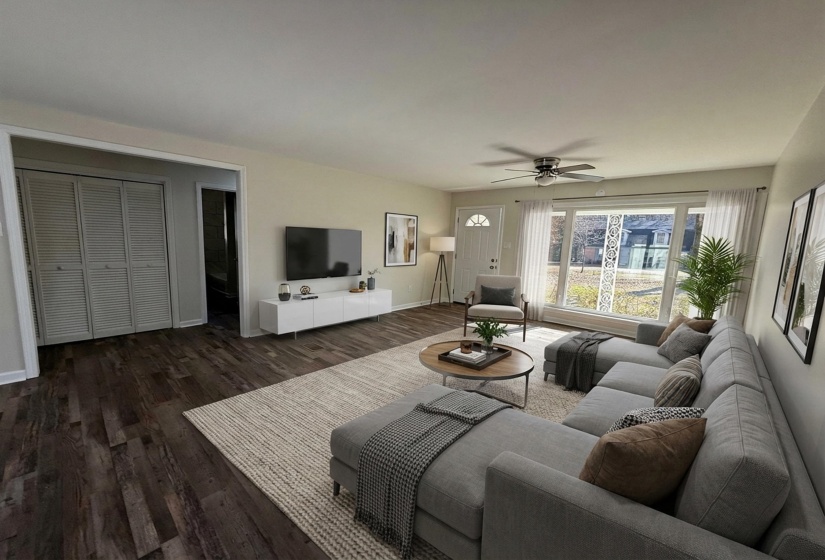 Living room with dark wood finished floors and ceiling fan