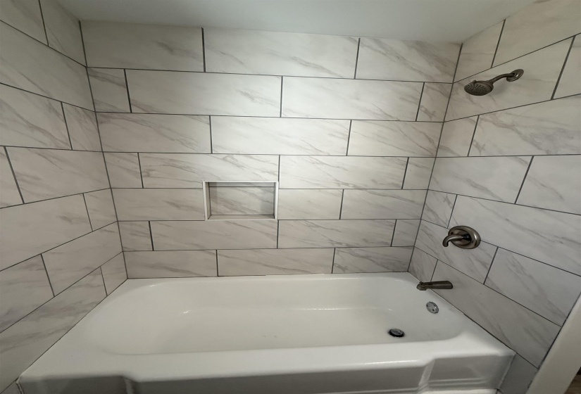 Bathroom featuring washtub / shower combination