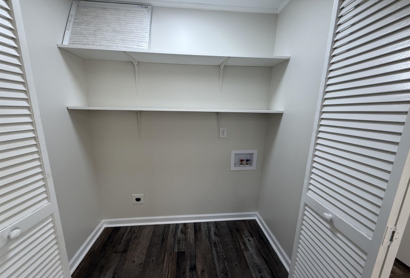 Laundry room with washer hookup, electric dryer hookup, and dark wood-type flooring