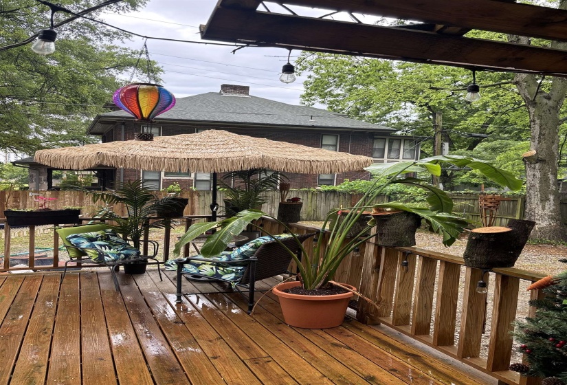Spacious outdoor deck featuring wooden plank flooring and perimeter railing