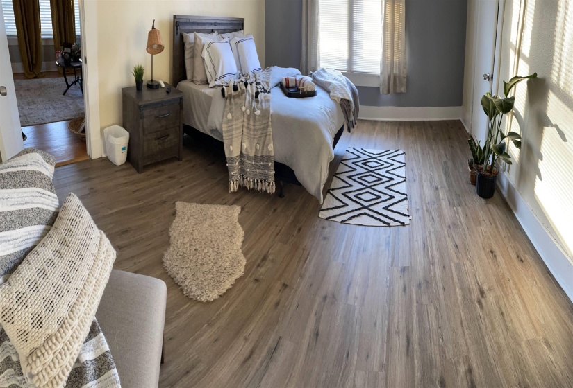 Spacious room featuring wood-finish flooring and a light color palette