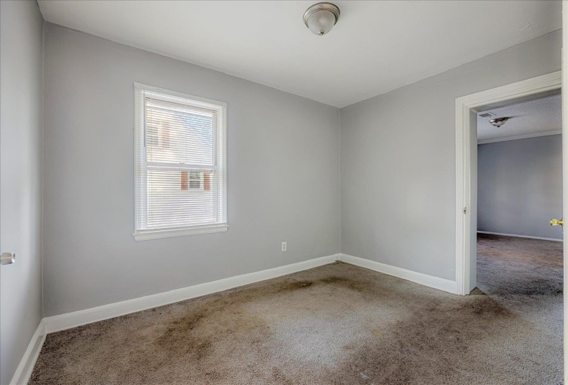 Empty room featuring carpet floors and baseboards