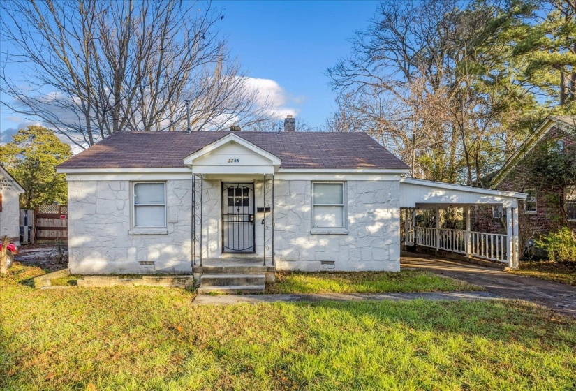 Bungalow-style home with crawl space, roof with shingles, a carport, and a front yard