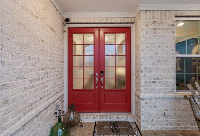 Property entrance with brick siding and french doors