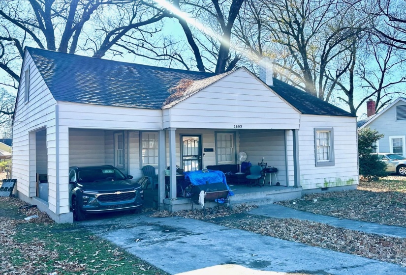View of front of home with a porch, roof with shingles, and crawl space