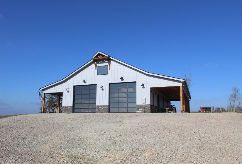 Garage featuring a garage and driveway