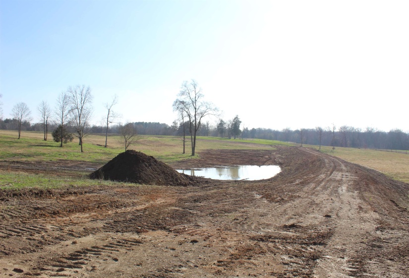 View of storm shelter with a view of countryside and a water view