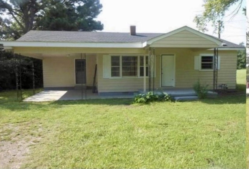 Rear view of property featuring a yard