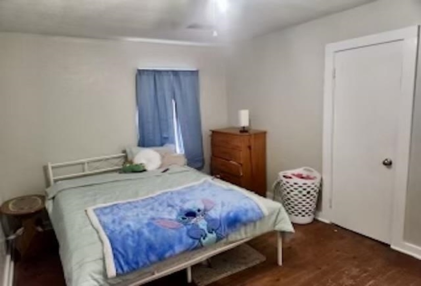 Bedroom with wood-type flooring