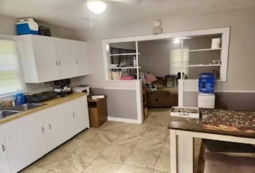 Kitchen with white cabinets and light tile patterned floors