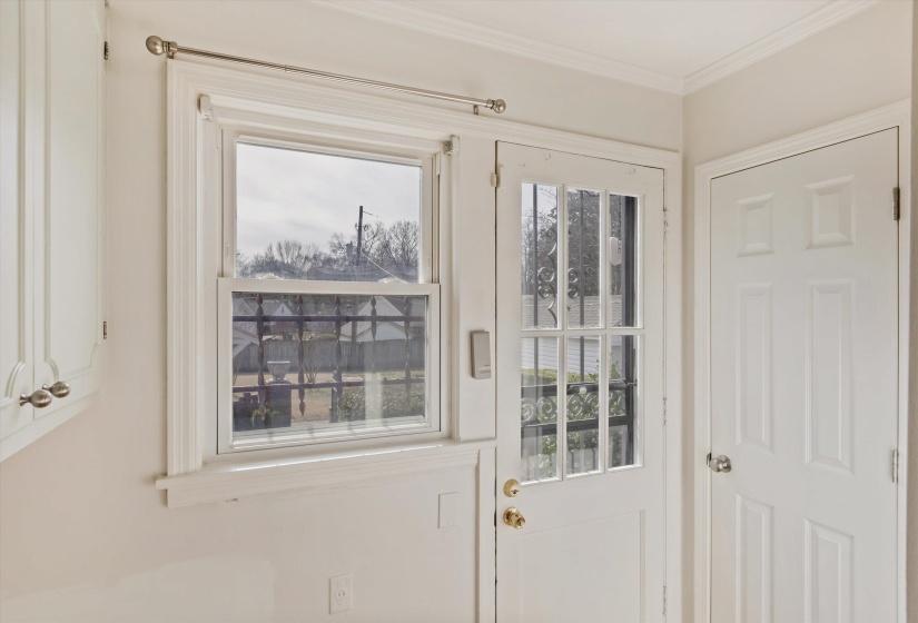 Doorway to outside featuring plenty of natural light and ornamental molding