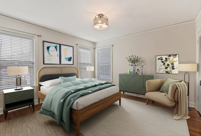 Bedroom featuring wood finished floors and multiple windows. (Virtually staged)
