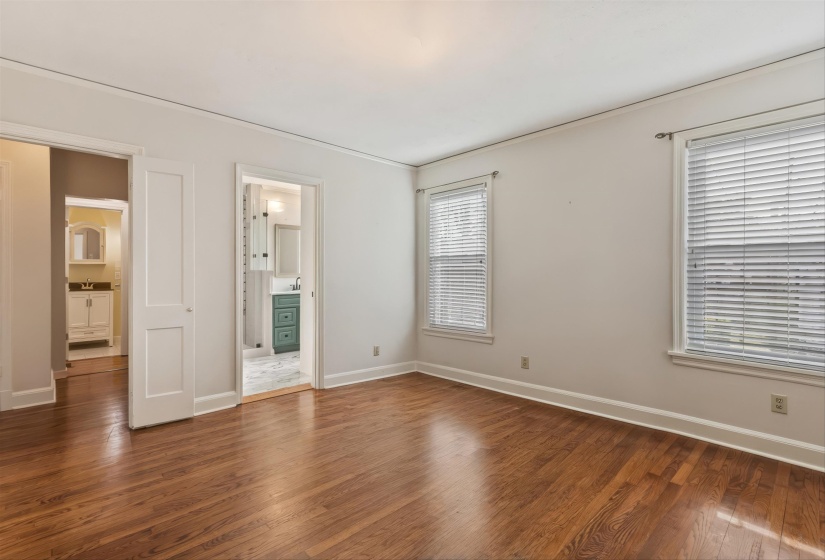 bedroom with dark wood-style flooring and ensuite bath