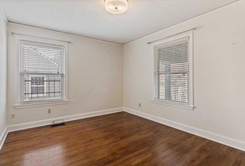 Room featuring dark wood-style floors and baseboards