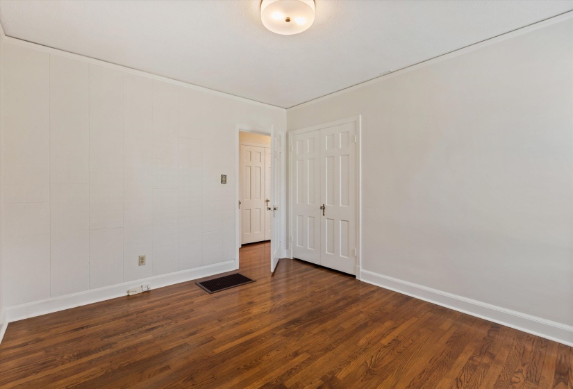 Room with dark wood-style floors and baseboards