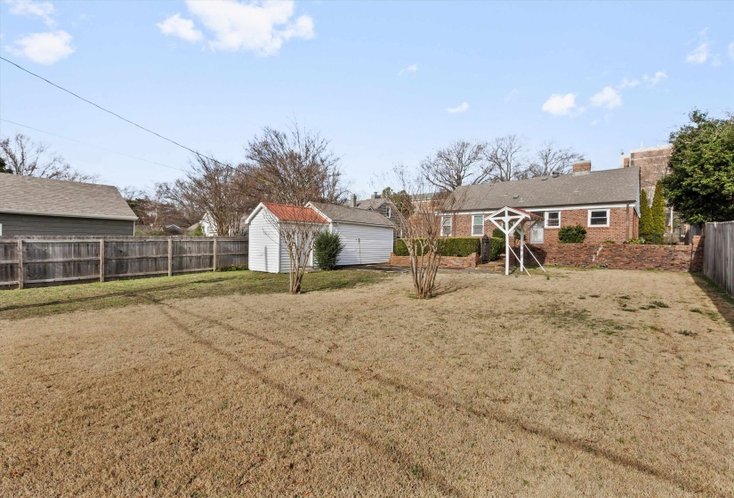 Fenced backyard with a storage shed
