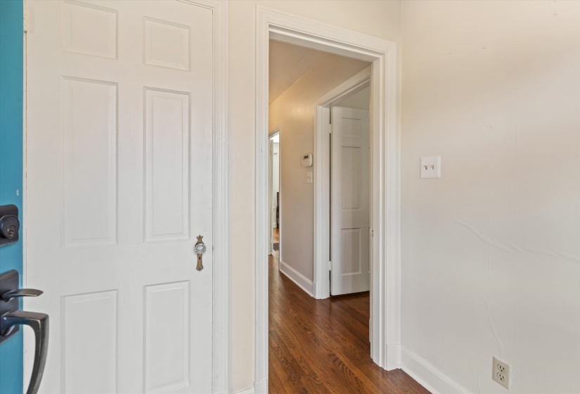 Hall featuring dark wood-type flooring and baseboards