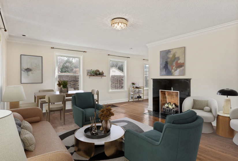 Living room with ornamental molding, a fireplace with flush hearth, and wood finished floors. (Virtually staged)