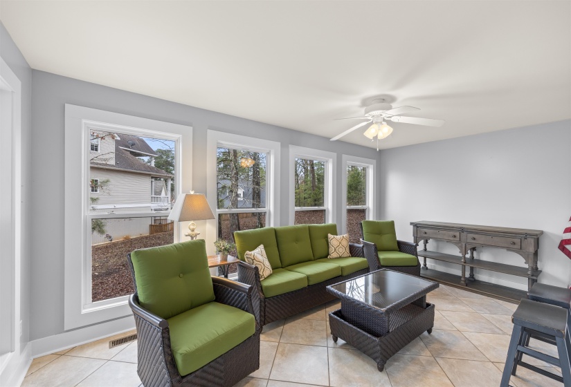 Living room with tile patterned floors and ceiling fan