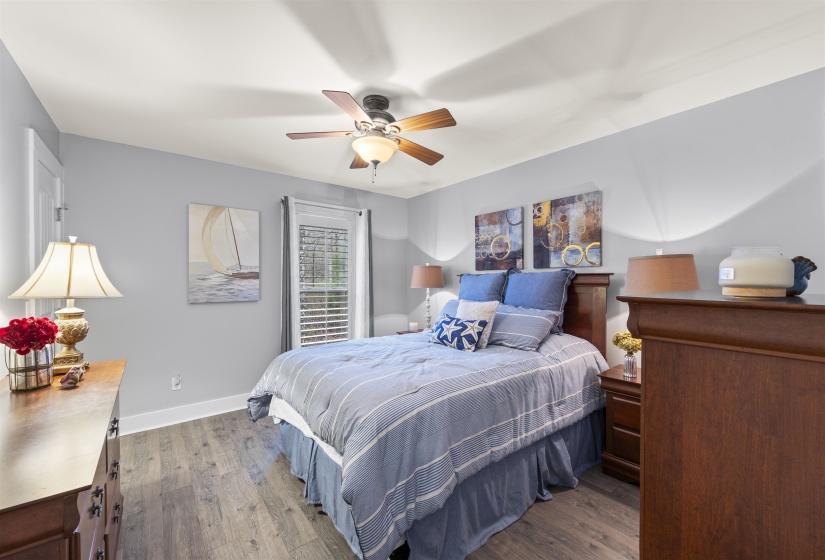 Bedroom with wood finished floors and a ceiling fan