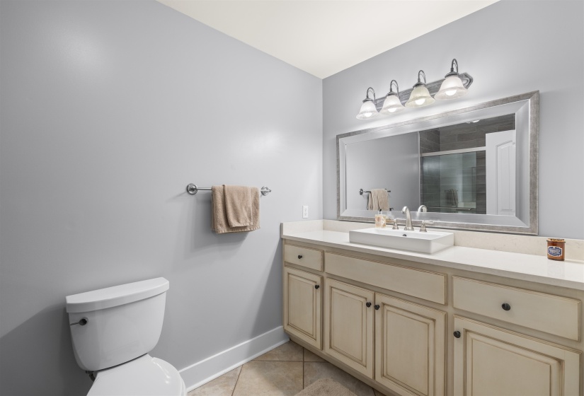 Full bath featuring a shower stall, vanity, and light tile patterned floors
