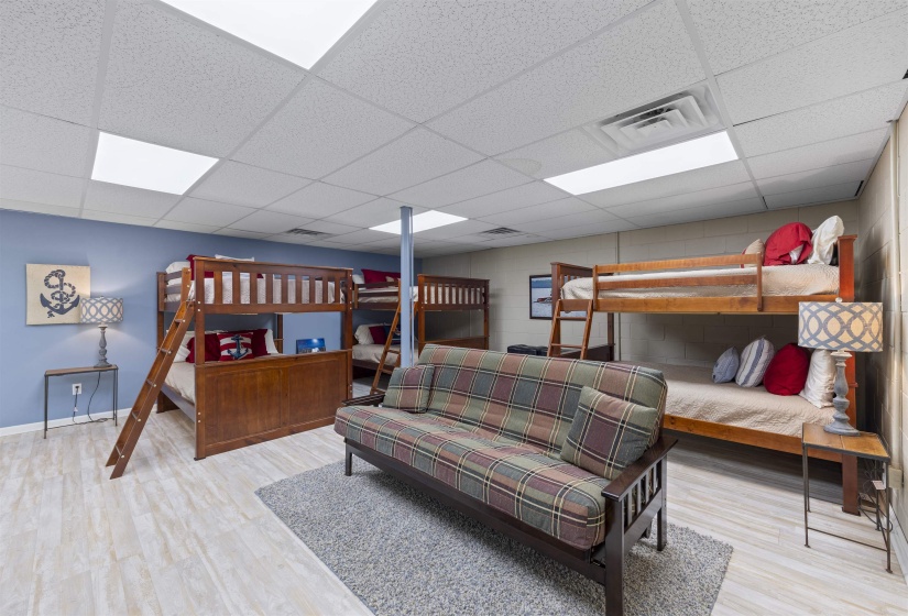Bedroom featuring light wood-type flooring and a drop ceiling