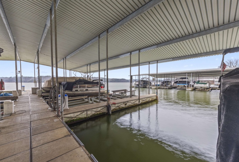 Dock area featuring boat lift and a water view
