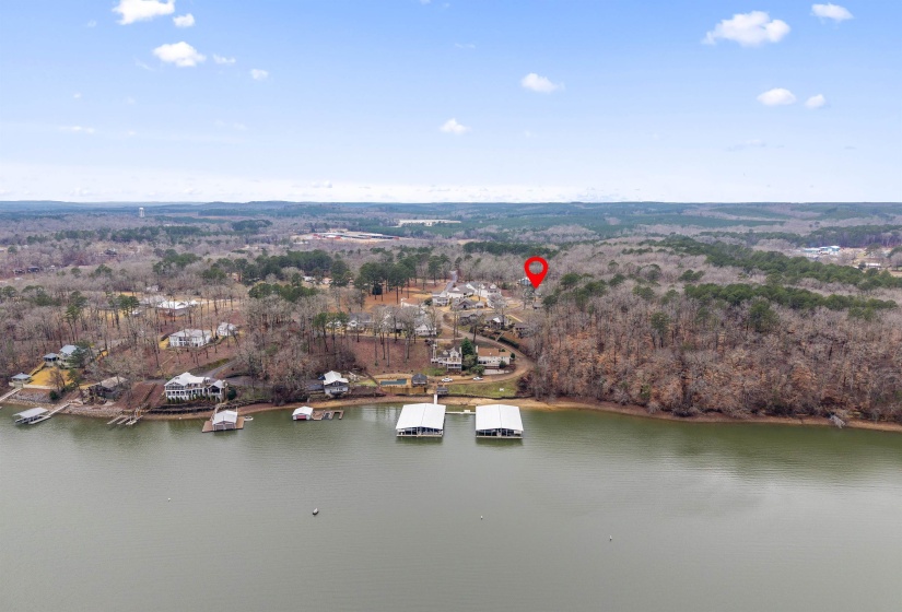 Aerial view of property and surrounding area featuring a large body of water