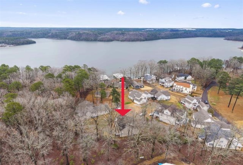 Aerial overview of property's location with a nearby body of water and nearby suburban area