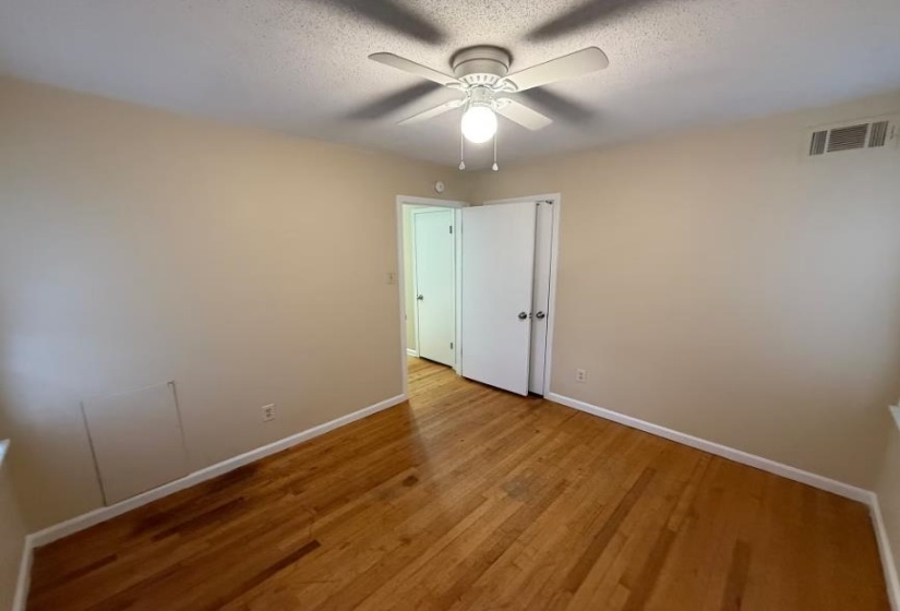 Spare room with light wood-style flooring, a textured ceiling, and ceiling fan