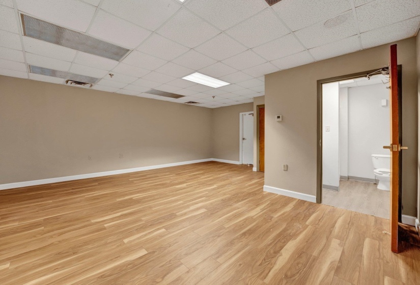 Unfurnished room with light hardwood / wood-style flooring and a paneled ceiling