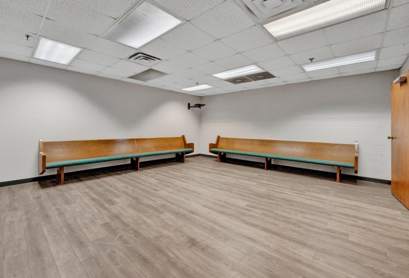 Misc room with a paneled ceiling and light hardwood / wood-style floors